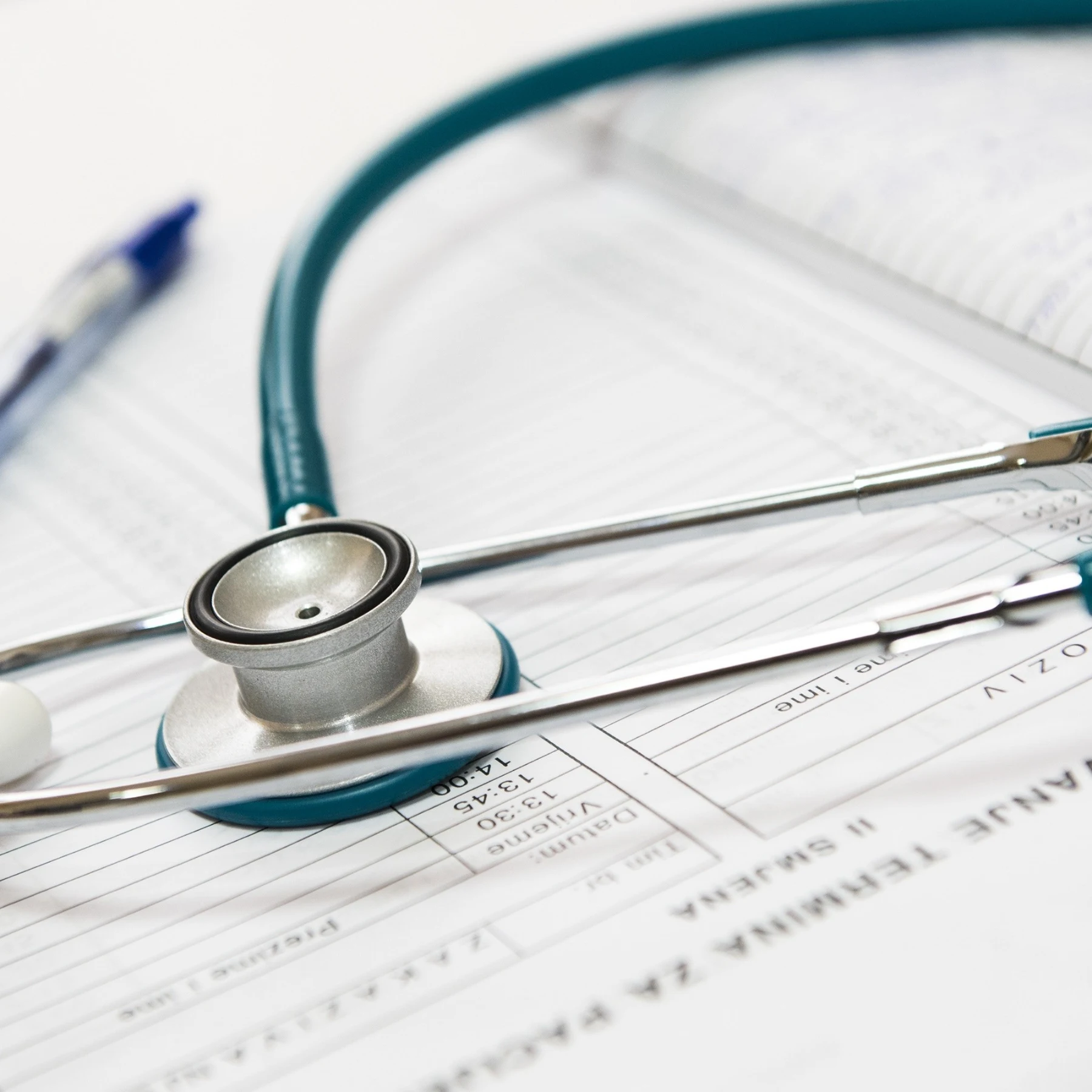 A stethoscope rests on a medical document, symbolizing healthcare and patient assessment.